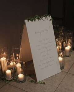 Order of the day a-board surrounded by candles at Askham Hall with Tebbey and Co
