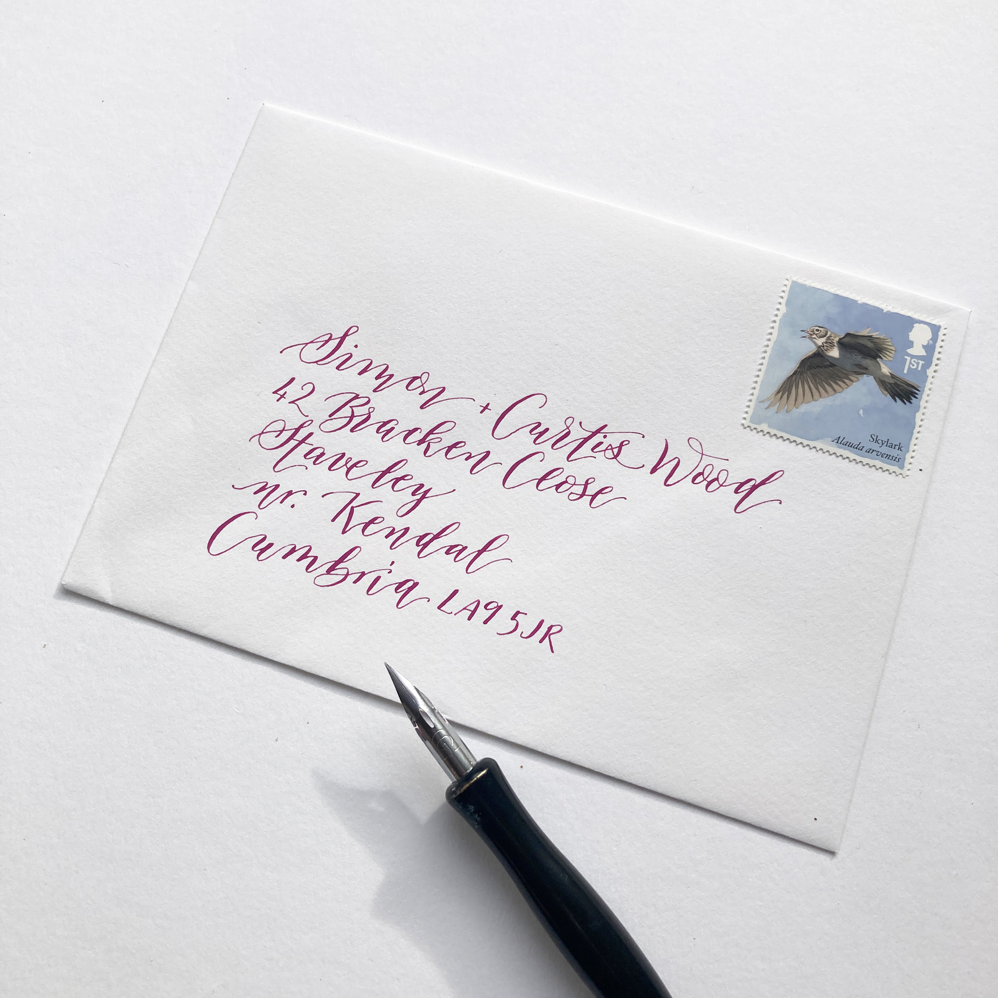 Playful calligraphy style on an envelope in vibrant pink ink
