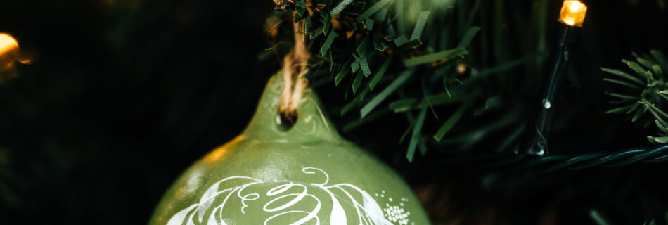 Pale olive green painted bauble personalised in calligraphy with a name