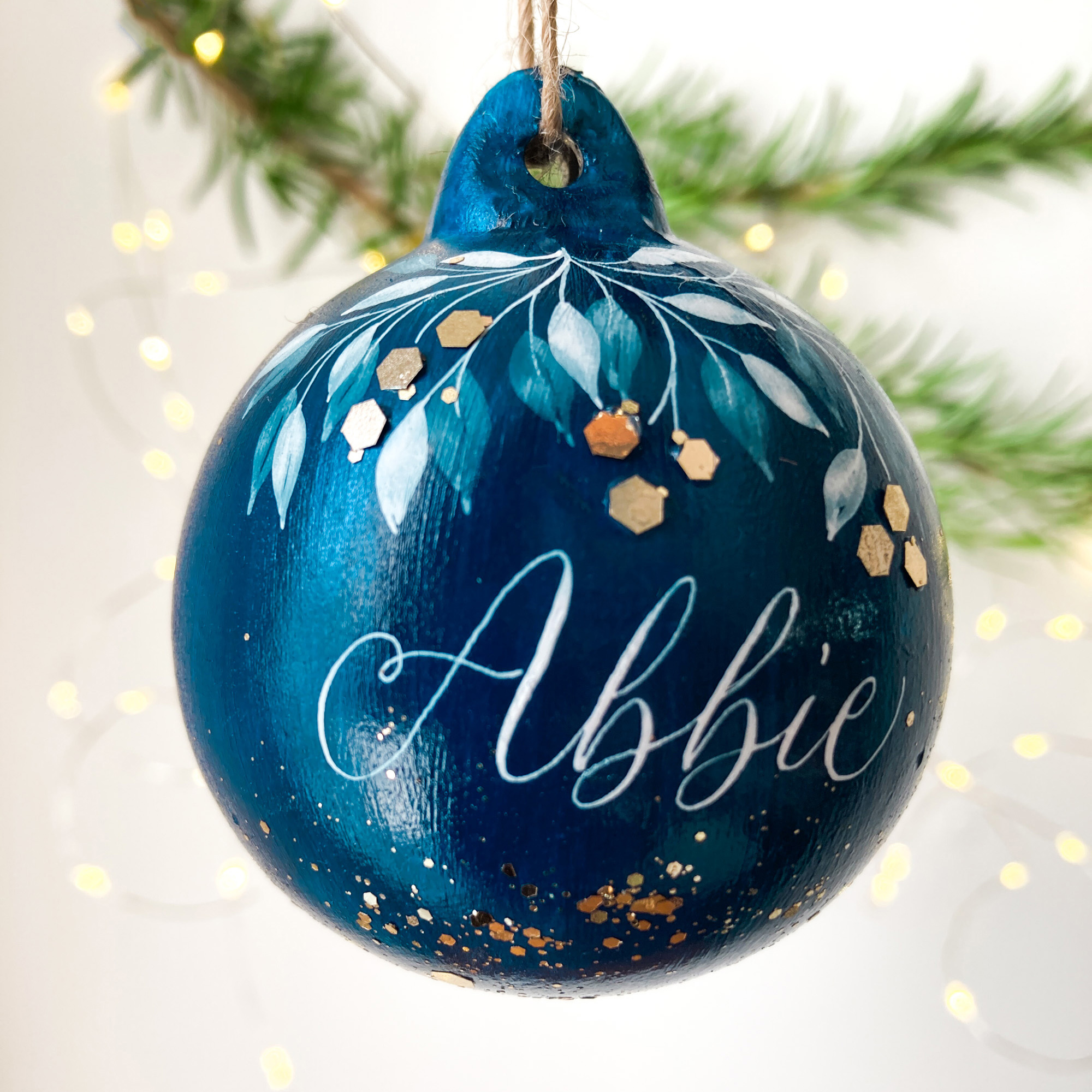 personalised Christmas name bauble made in the UK with calligraphy