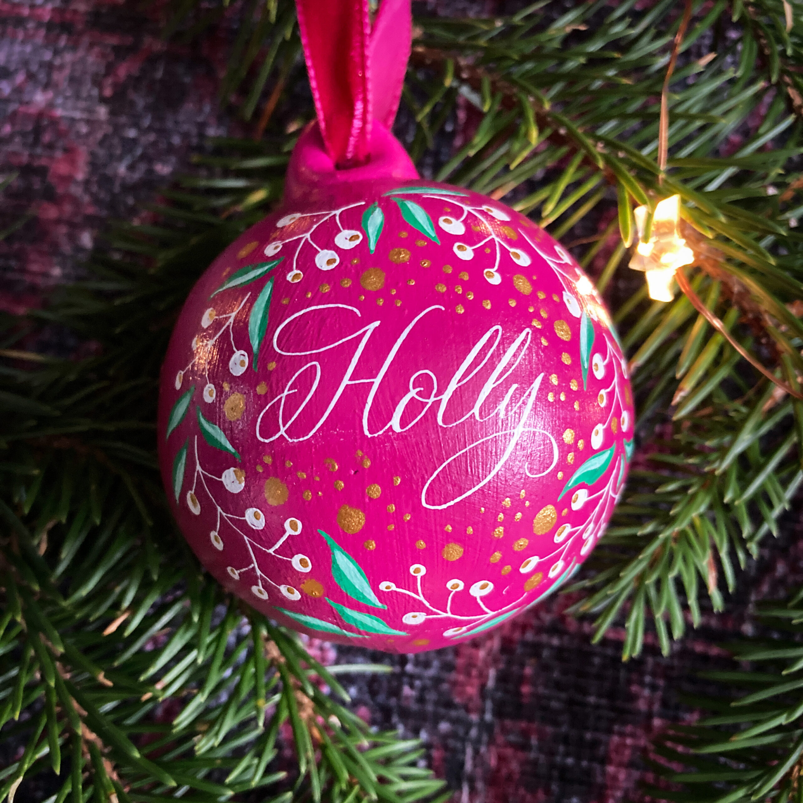 personalised Christmas name bauble made in the UK with calligraphy