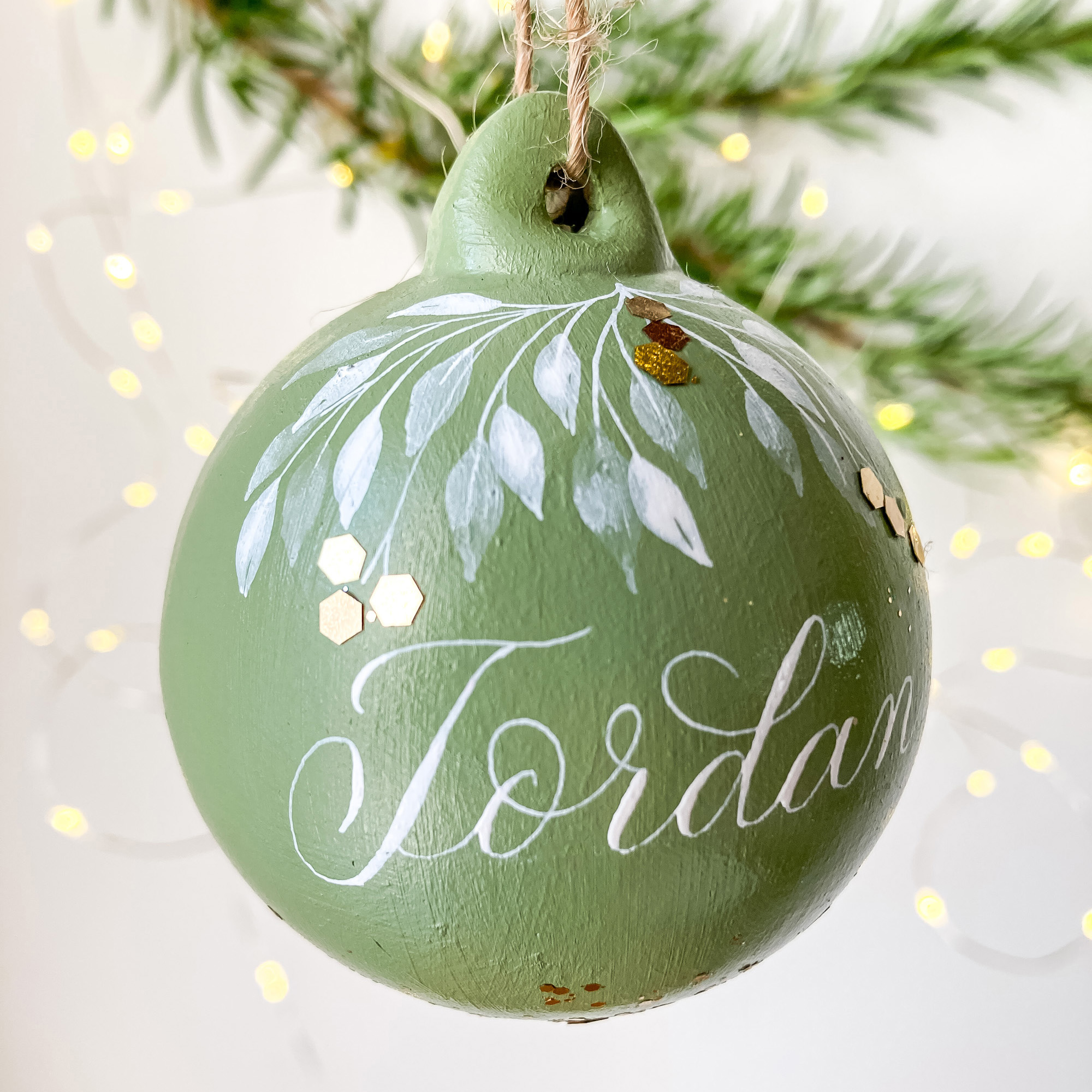 personalised Christmas name bauble made in the UK with calligraphy