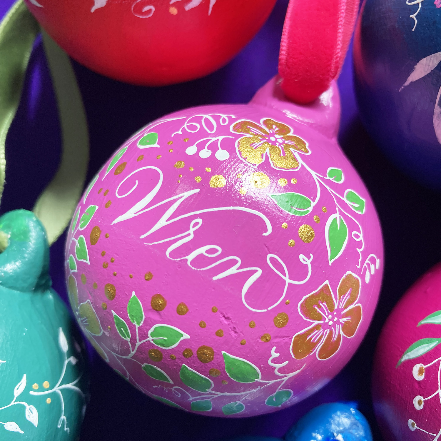 personalised Christmas name bauble made in the UK with calligraphy