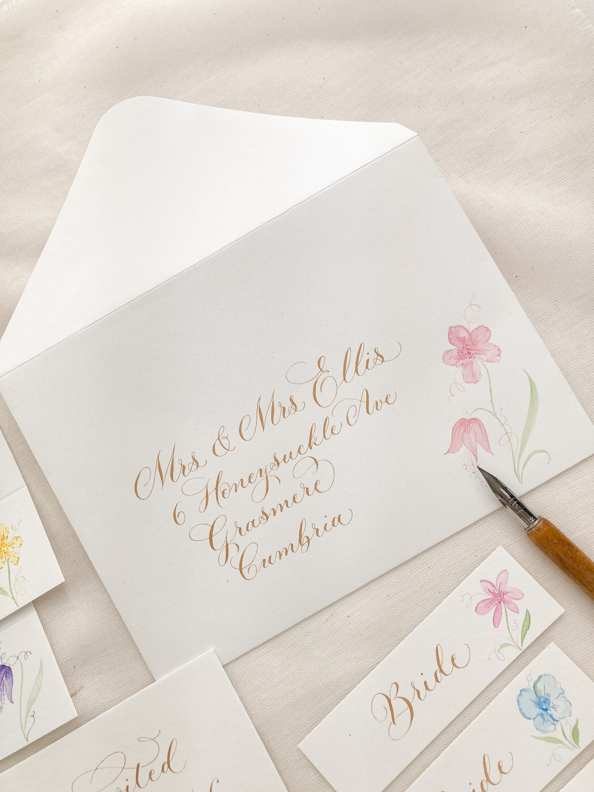 Handwritten wedding envelope to Mrs & Mrs Ellis written and illustrated by UK calligrapher Claire Gould at By Moon & Tide Calligraphy in Cumbria