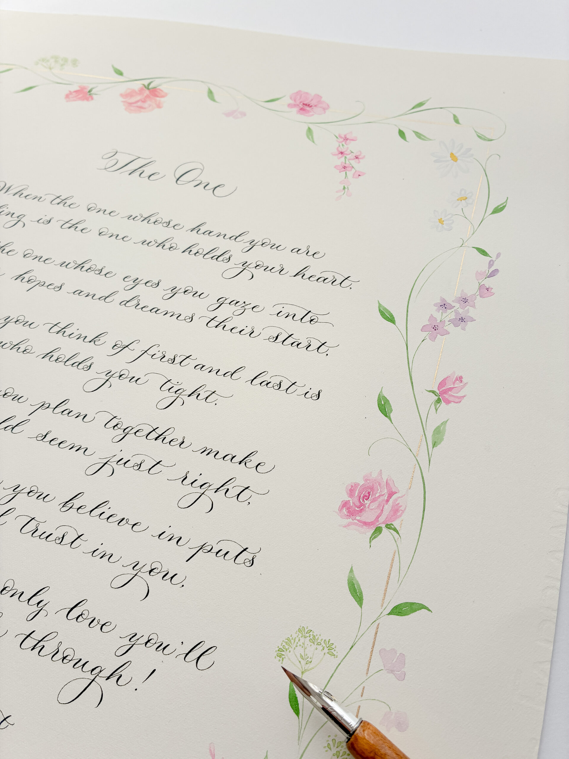 Top corner of a calligraphy commission showing the dip pen in one corner, and a border illustration wrapping around the text, with pink and purple floral illustrations, daisies, sweet peas and fennel