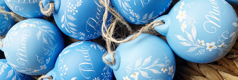 Christmas baubles painted by hand and personalised in calligraphy