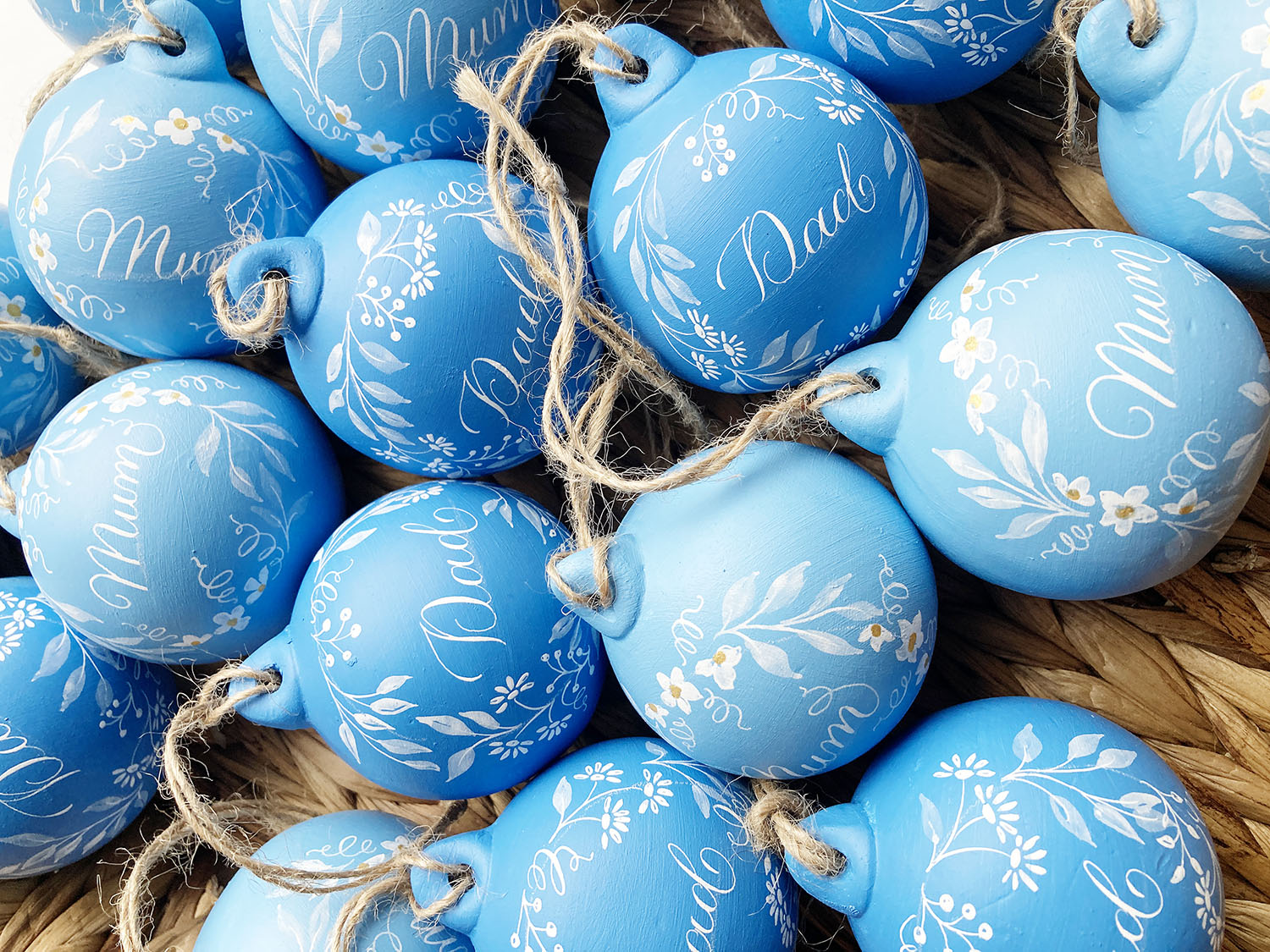 Christmas baubles painted by hand and personalised in calligraphy